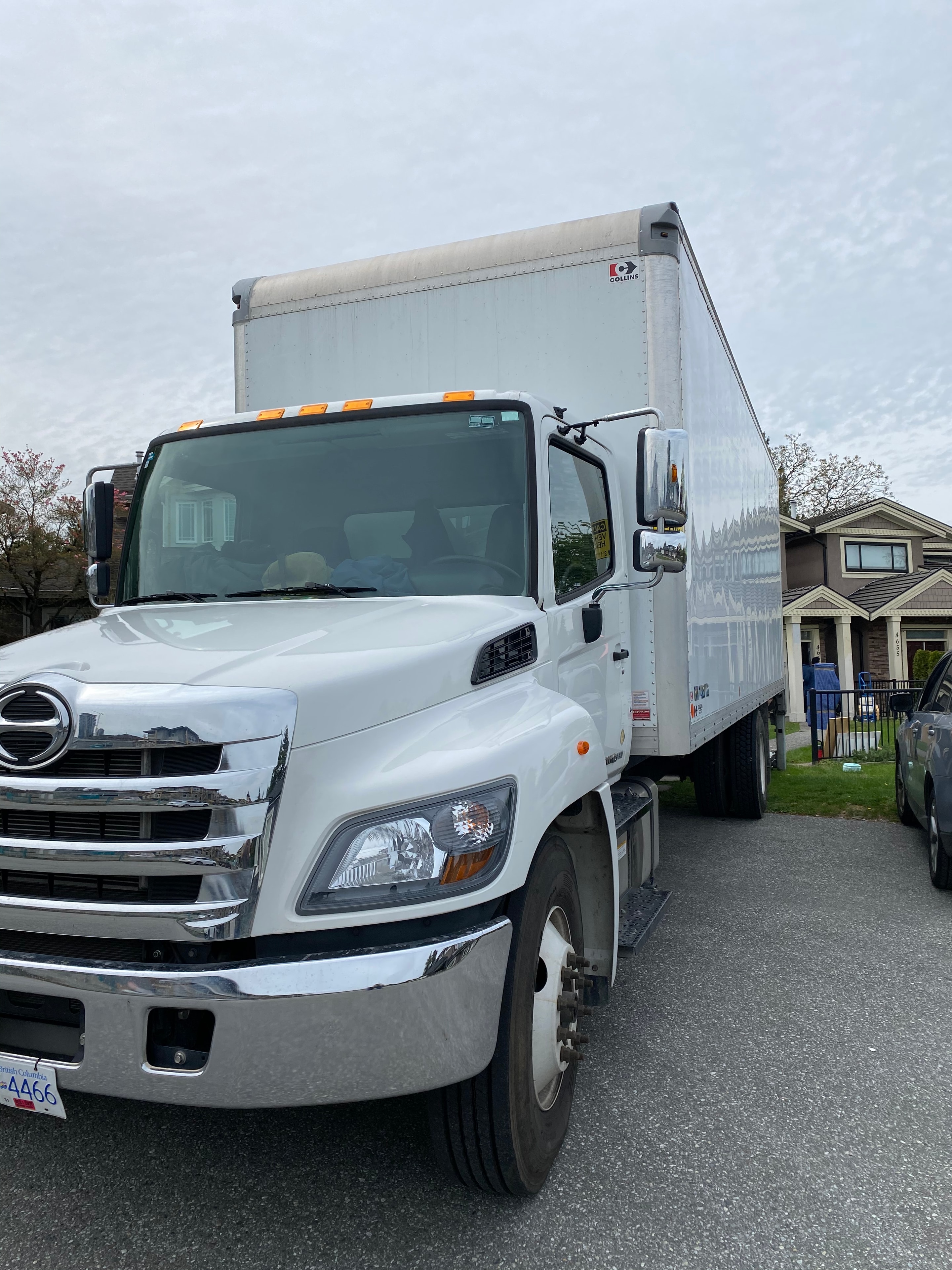 White delivery truck parked at residential driveway
